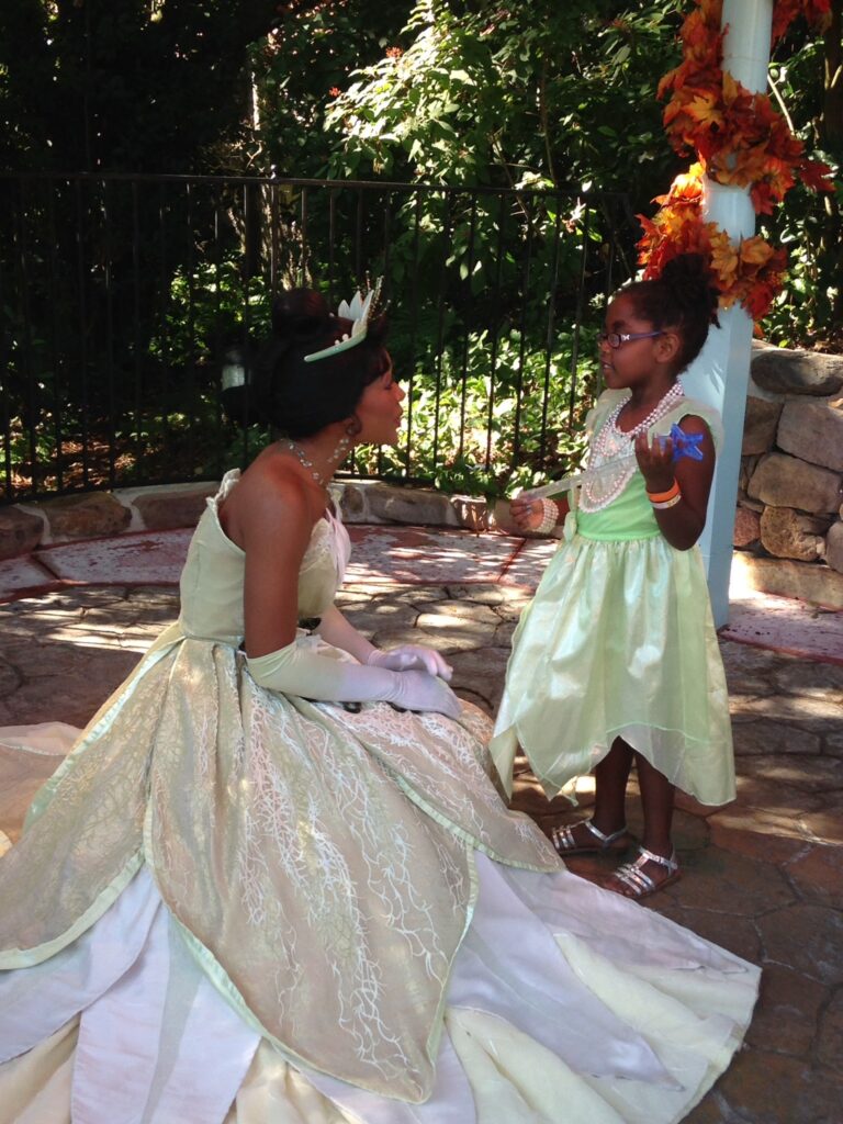 Tiana with little girl at Disney 