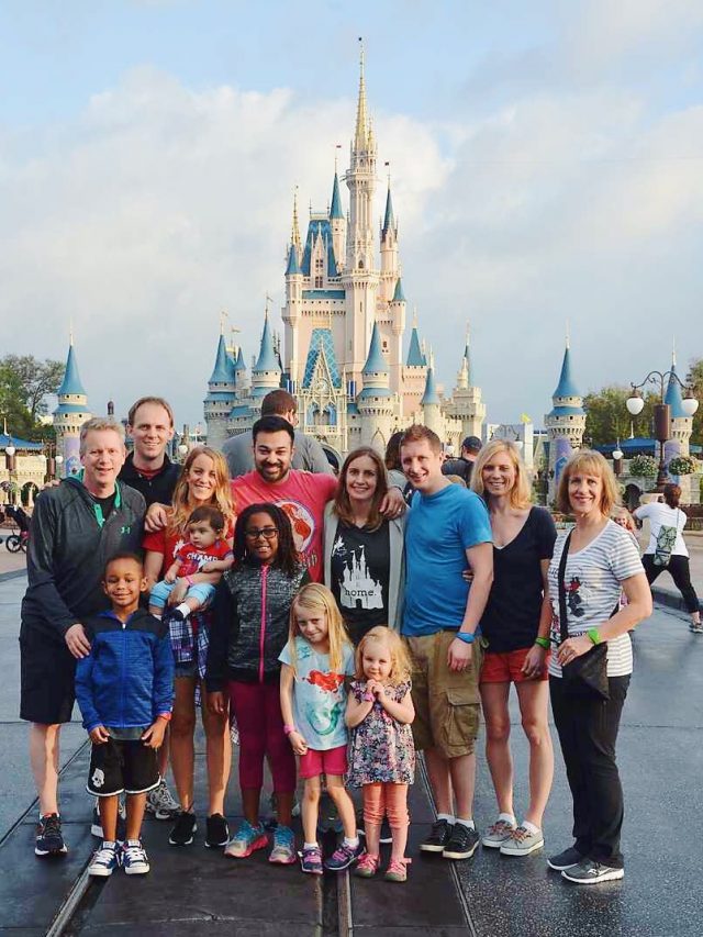 family in front of Disney Castle