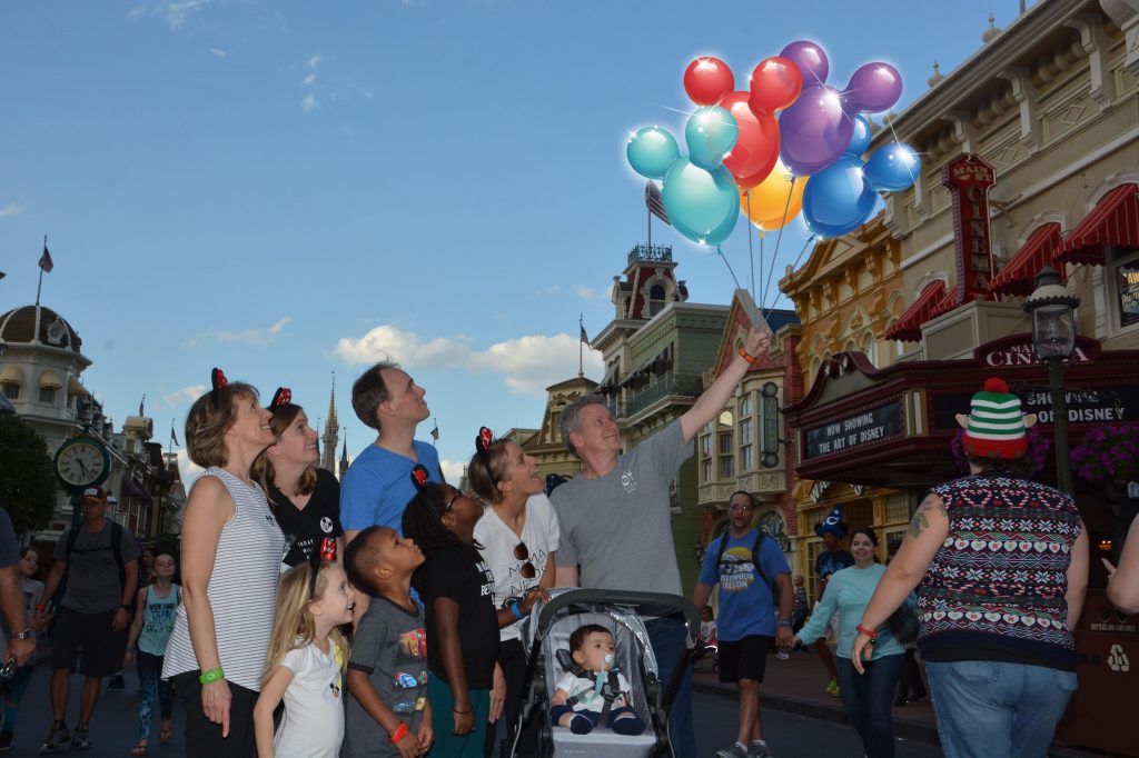 family with mickey balloons Main Street usa
