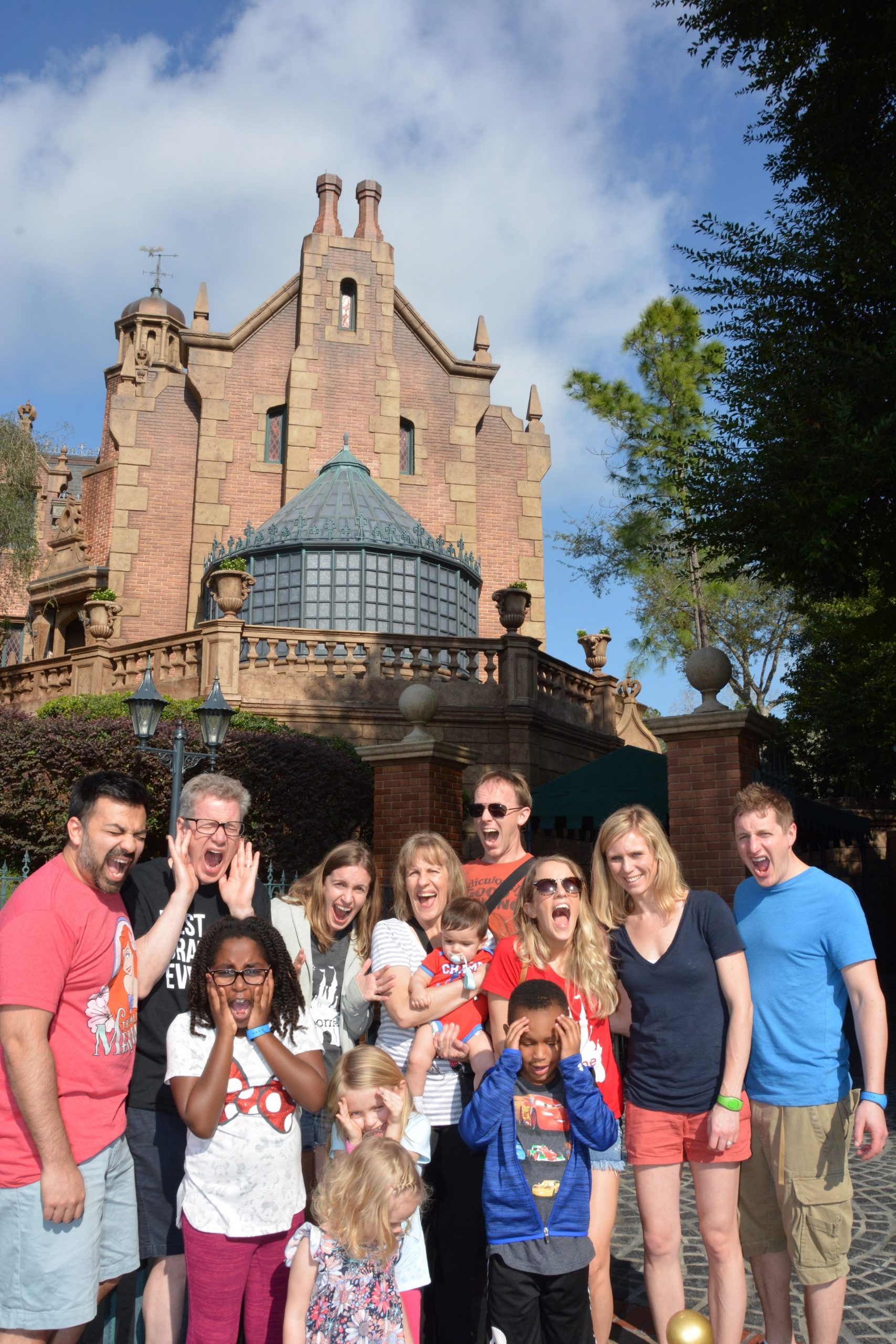 family in front of haunted mansion