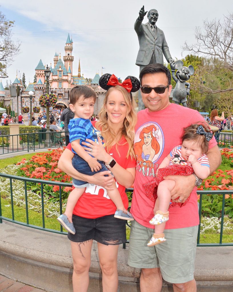 family in front of disney land castle