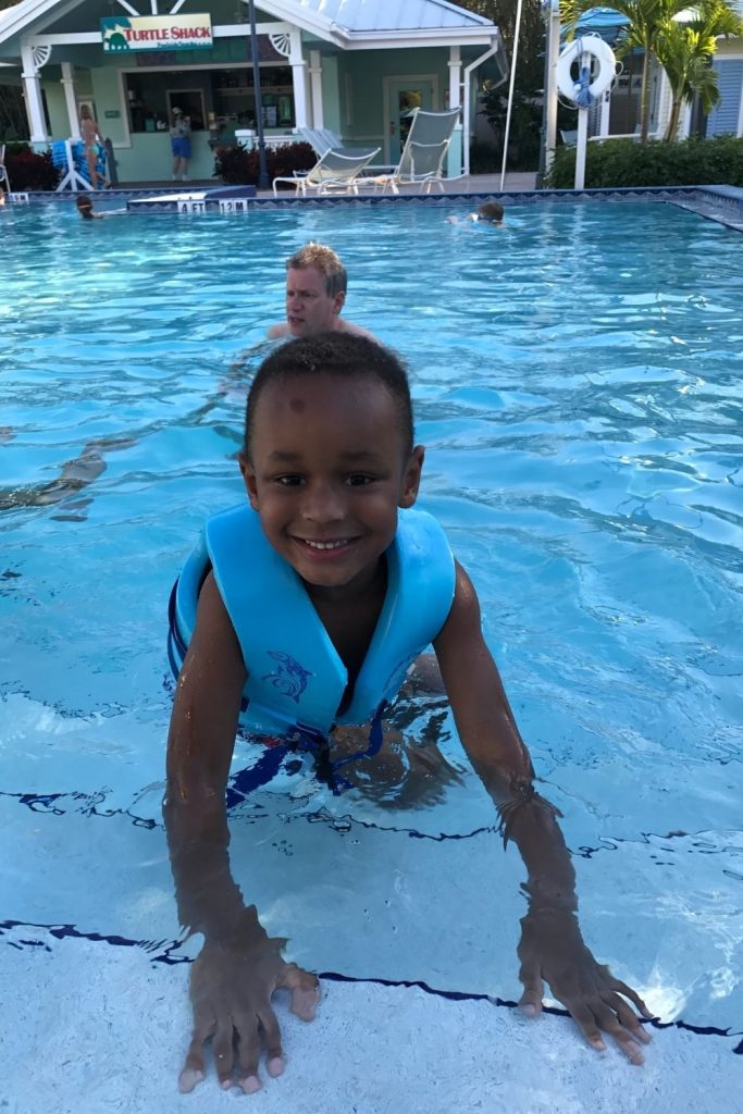 boy swimming at disney pools