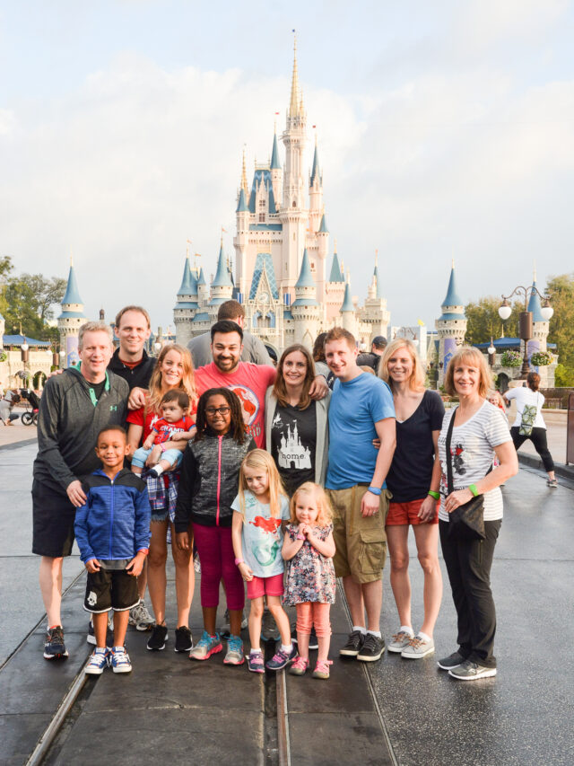 family in front of disney castle