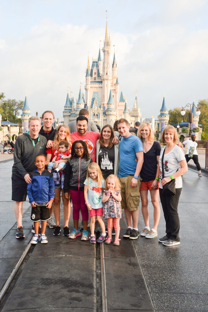 family at disney world in front of castle