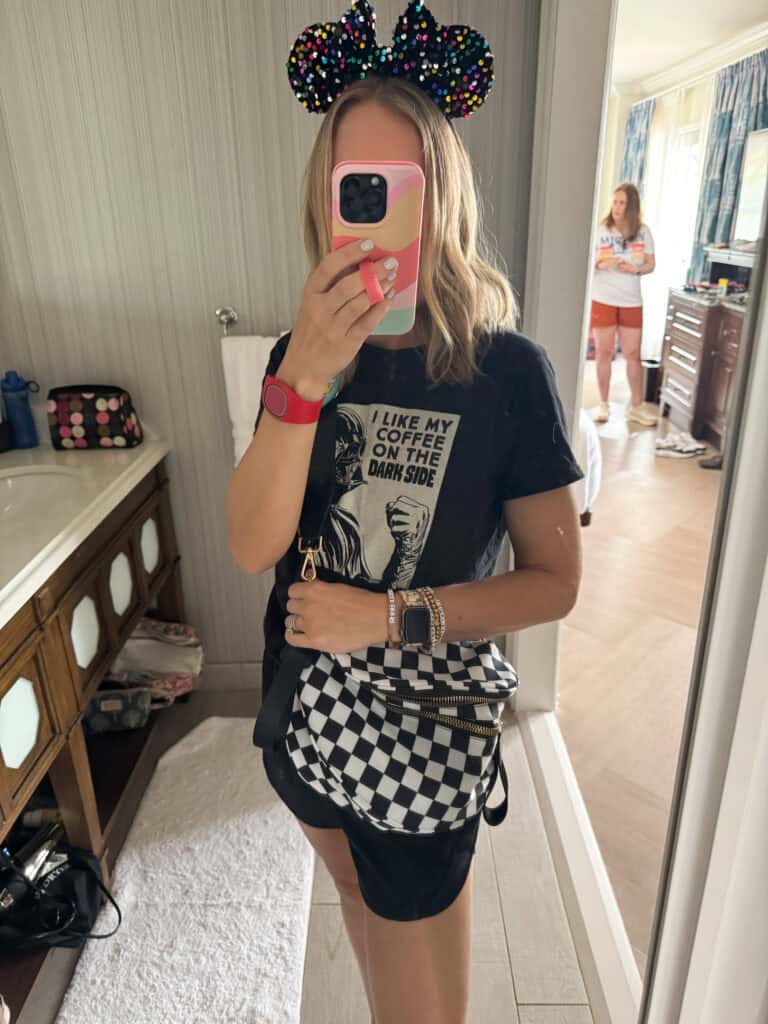 Woman with checkered bag and mickey ears.