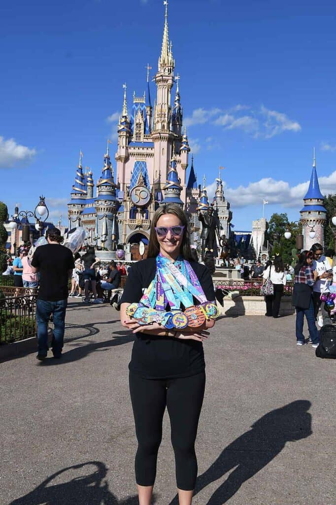 woman with medals after rundisney event