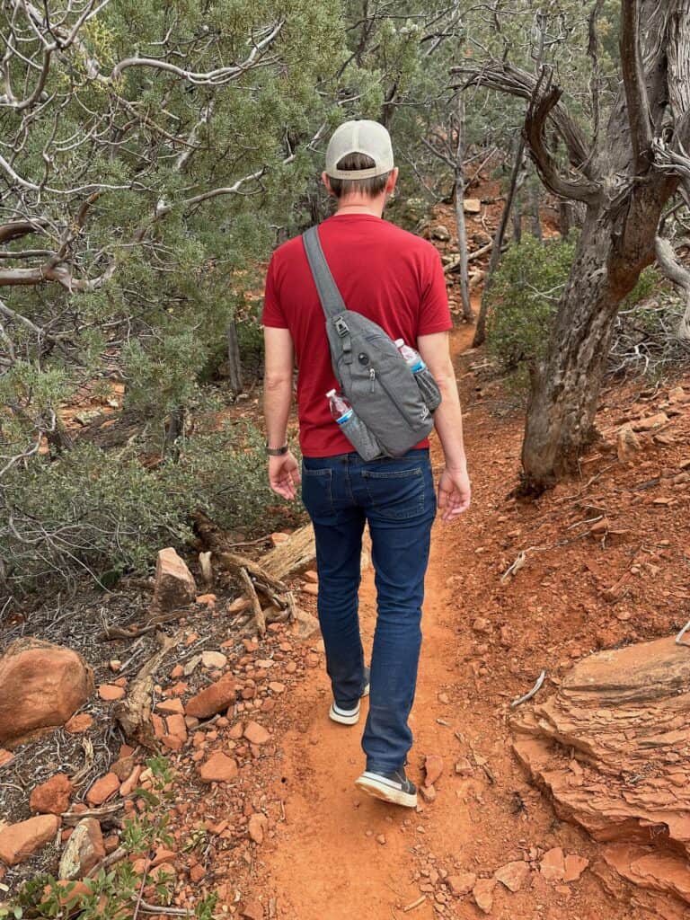 Man wearing crossbody backpack while hiking