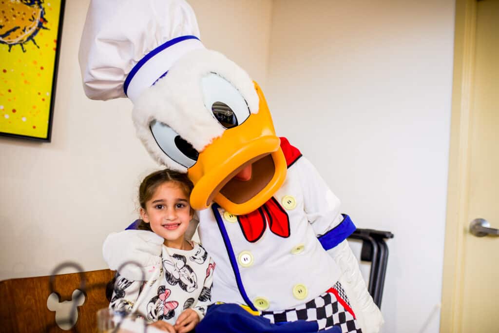 girl with donald duck at chef mickey