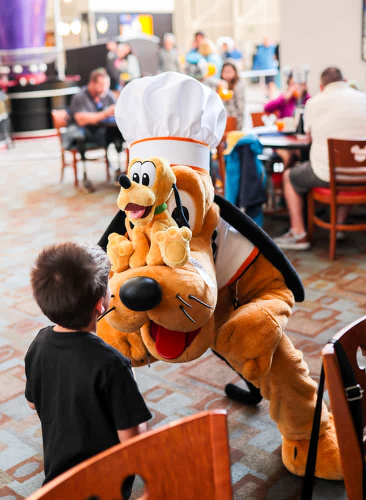 boy with pluto at chef mickey