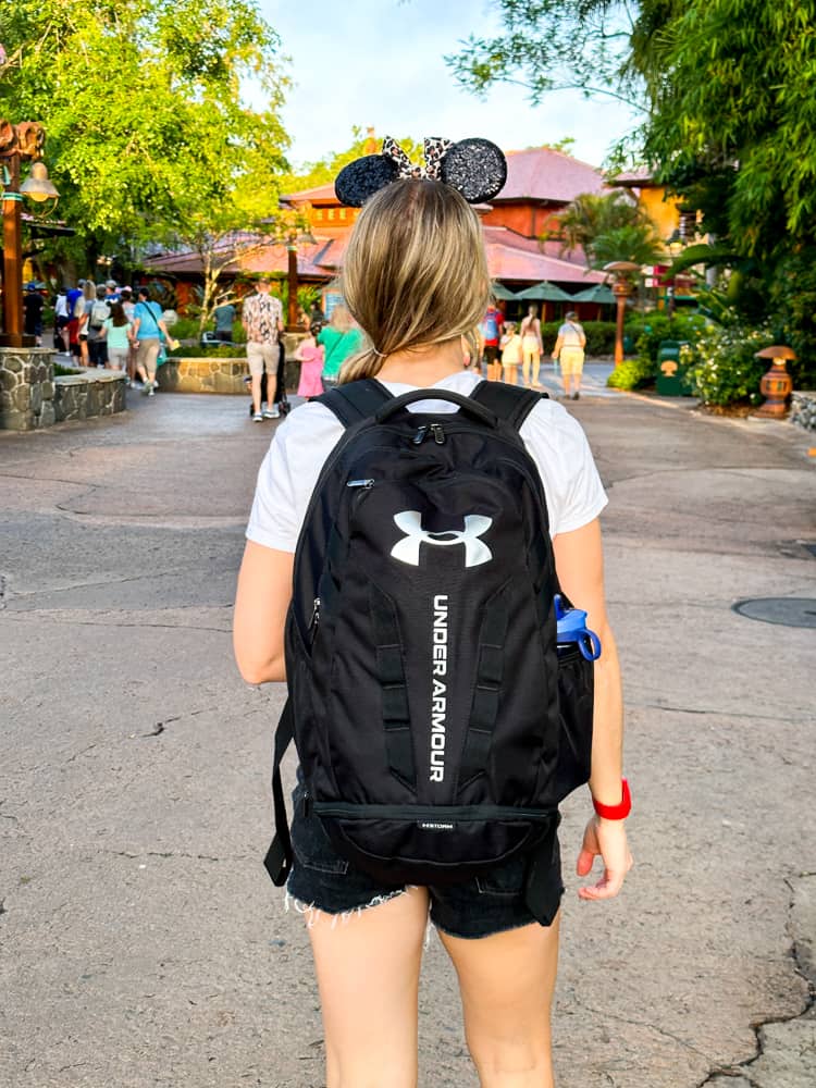 woman wearing a backpack at disney world