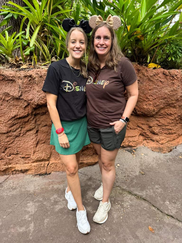 2 women in disney outfits.