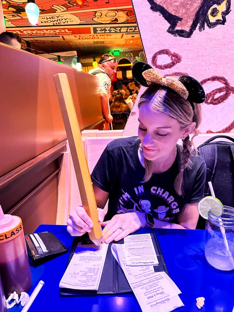 signing with a giant pencil at woody's rodeo roundup 