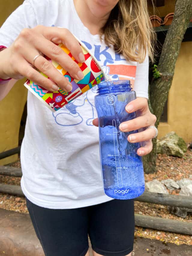 pouring water into a water bottle at disney world
