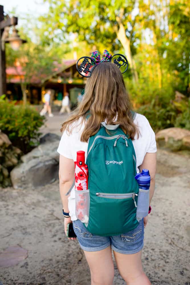 woman wearing disney backpack