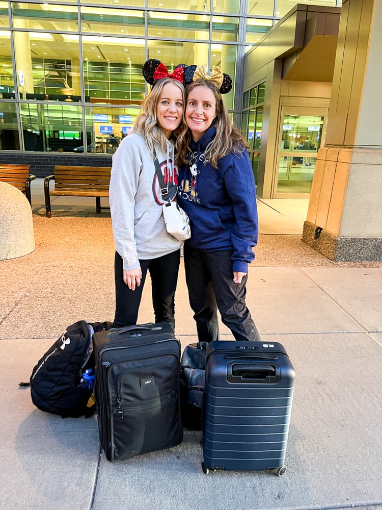 2 women heading out on a disney vacation at the airport