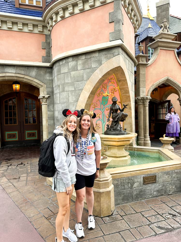 Two women at Cinderella's well in Magic Kingdom