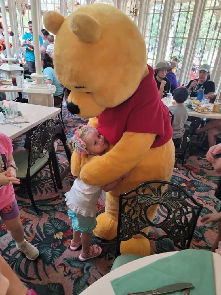 little girl hugging winnie the pooh