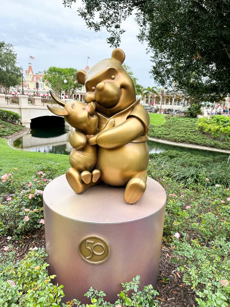 winnie the pooh and piglet statue at walt disney world's magic kingdom