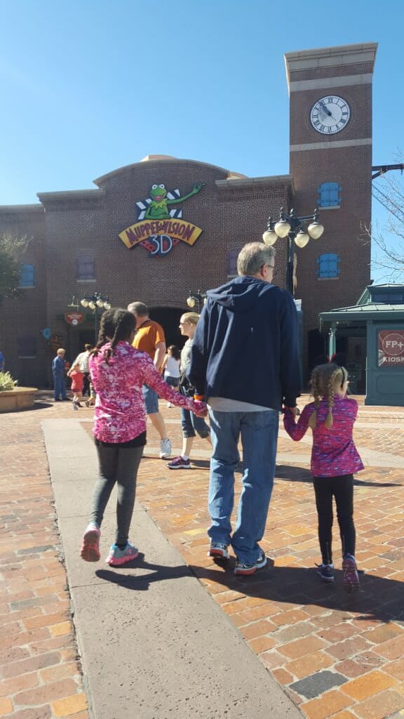 grandpa and 2 girls going to muppet 3d