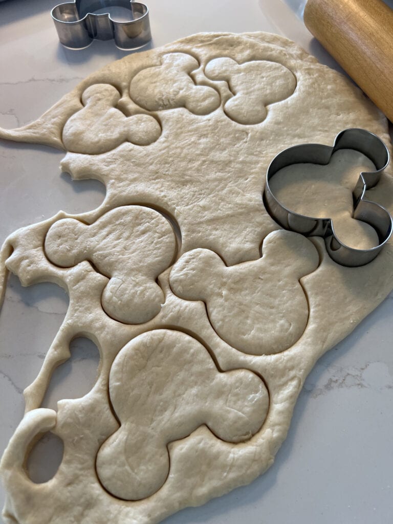 cutting out Mickey Mouse beignets