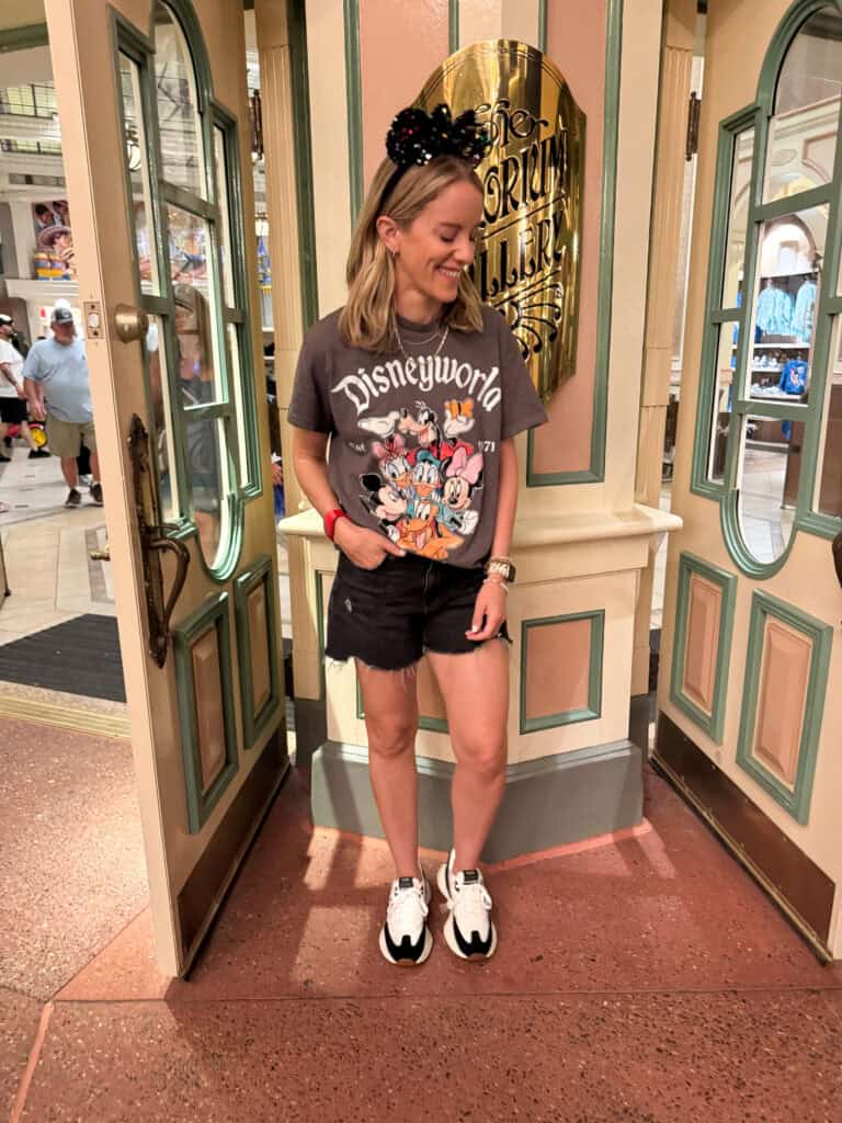 Woman in classic disney character shirt at disney world.